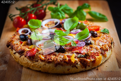 Image of Traditional homemade pizza with tomatoes and olives