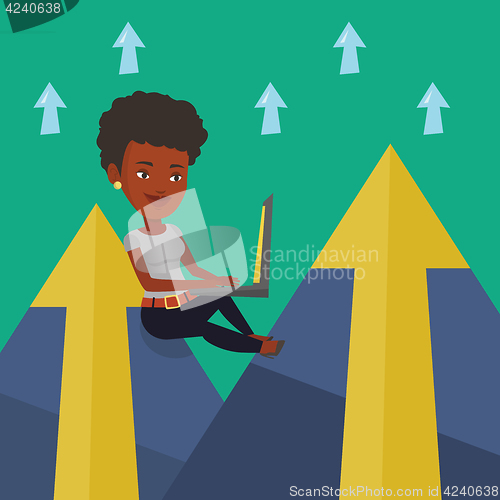 Image of Business woman working on laptop in the mountains.