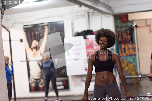 Image of black woman lifting empty bar