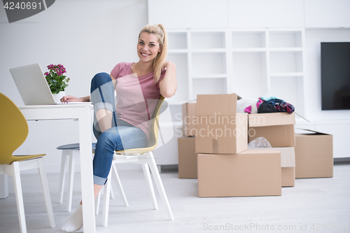 Image of Young woman moving in a new home