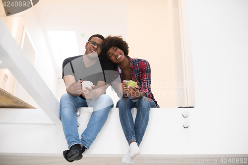 Image of couple having break during moving to new house