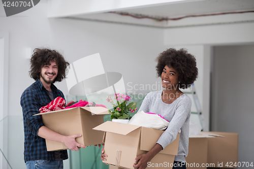 Image of multiethnic couple moving into a new home