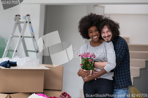 Image of multiethnic couple moving into a new home