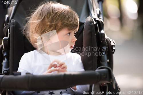 Image of baby girl sitting in the pram