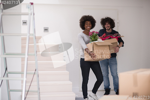 Image of multiethnic couple moving into a new home