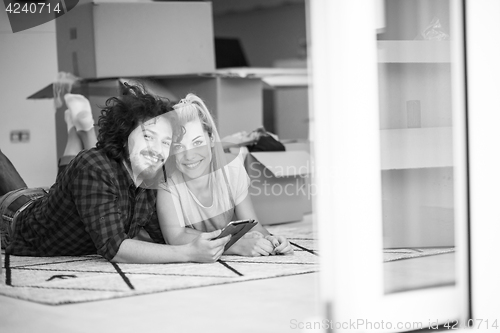 Image of Young couple moving in a new flat