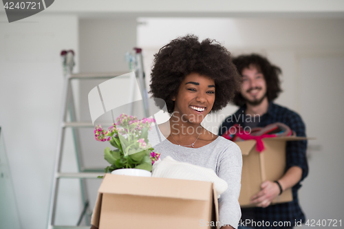 Image of multiethnic couple moving into a new home