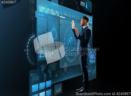 Image of businessman with virtual screens projection