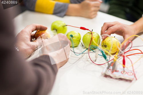 Image of kids hands with invention kit at robotics school