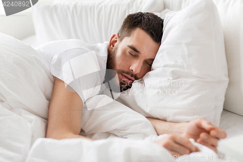 Image of close up of man sleeping in bed at home