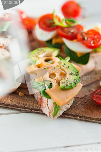 Image of The baguette and cheese on wooden background