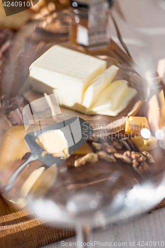 Image of The different kind of cheese and walnuts on wooden background