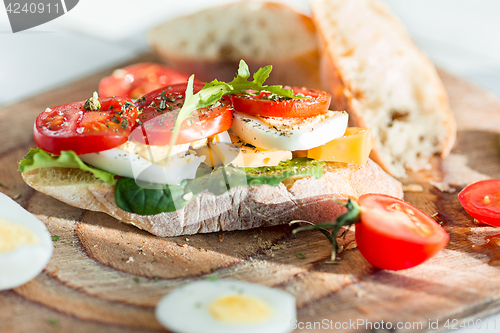 Image of The baguette and cheese on wooden background