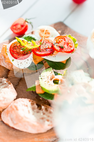 Image of The baguette and cheese on wooden background