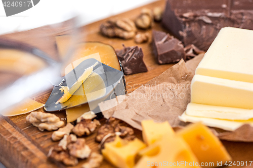 Image of The different kind of cheese and walnuts on wooden background