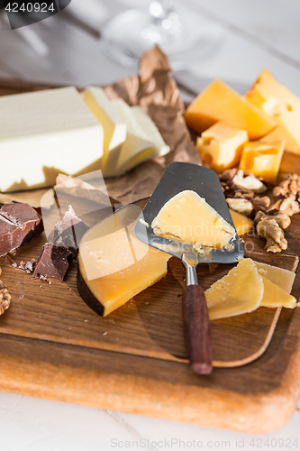 Image of The different kind of cheese and walnuts on wooden background