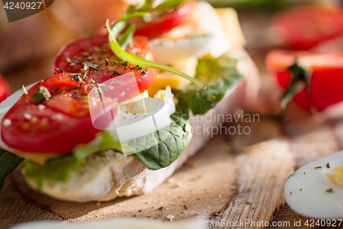 Image of The baguette and cheese on wooden background