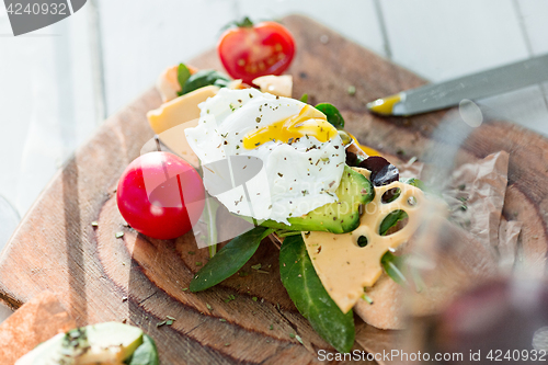 Image of The baguette and cheese on wooden background