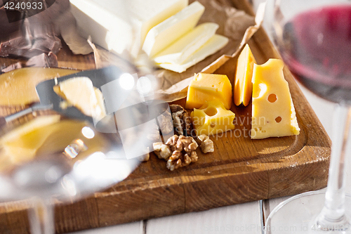 Image of Wine, baguette and cheese on wooden background