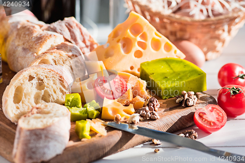 Image of The baguette and cheese on wooden background