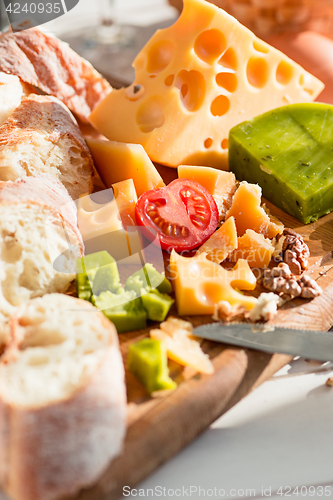 Image of The baguette and cheese on wooden background