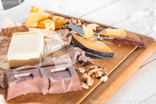 Image of The different kind of cheese and walnuts on wooden background