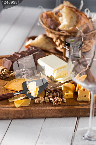 Image of The different kind of cheese and walnuts on wooden background