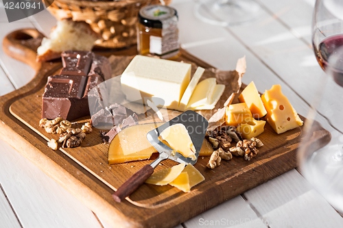 Image of The different kind of cheese and walnuts on wooden background