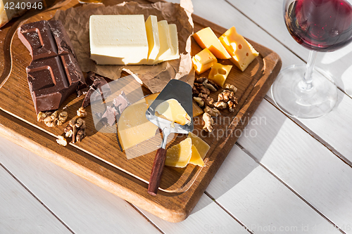 Image of The different kind of cheese and walnuts on wooden background