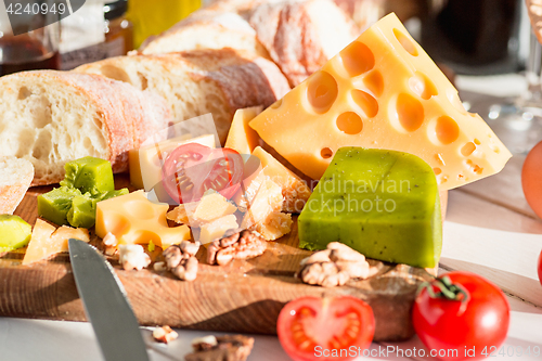 Image of The baguette and cheese on wooden background