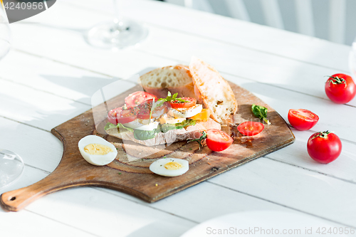 Image of The baguette and cheese on wooden background