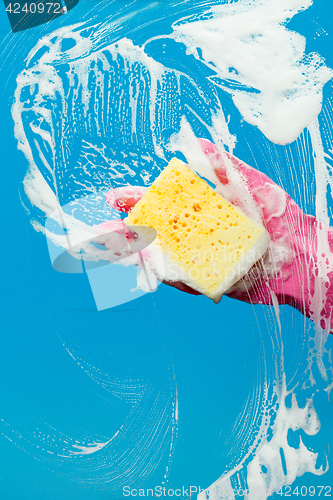 Image of Hand with glove cleaning window