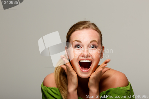 Image of Surprised model in green sweater