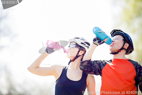 Image of Bicyclists drink water from bottle