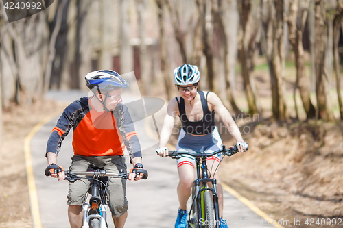 Image of Athletes in helmets on bicycles