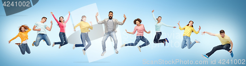Image of happy people or friends jumping in air over blue