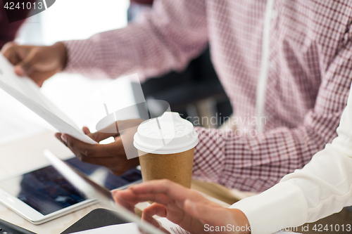 Image of business team with papers and coffee at office