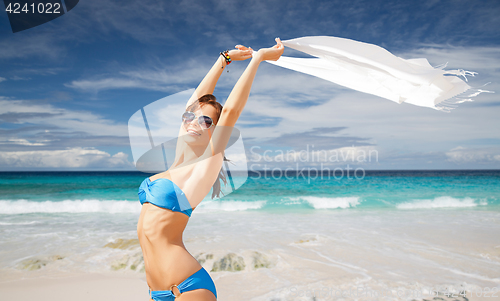 Image of woman in bikini and sunglasses with pareo on beach