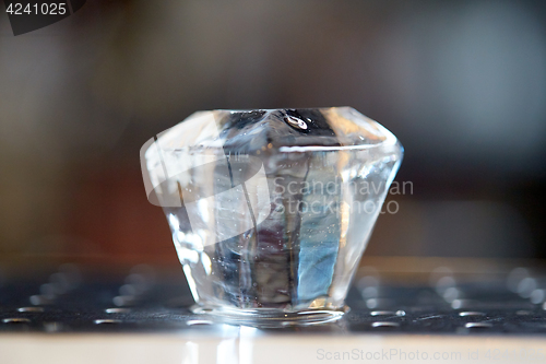 Image of curved ice cube at bar