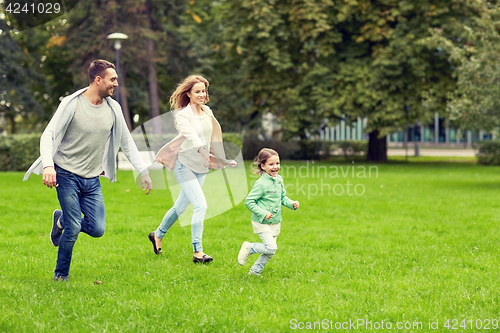 Image of happy family walking in summer park