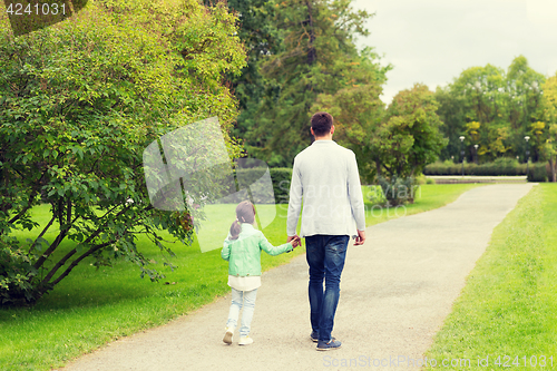 Image of happy family walking in summer park