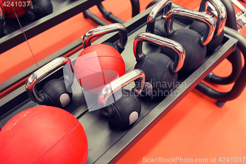 Image of close up of kettlebells and medicine ball in gym