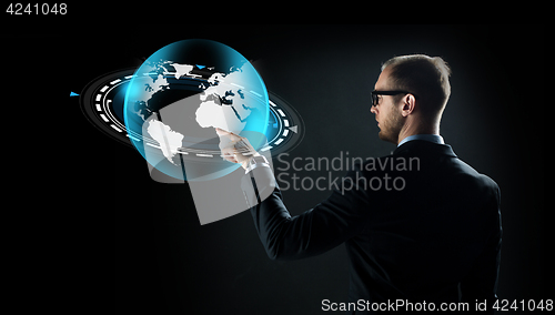 Image of businessman with virtual earth projection