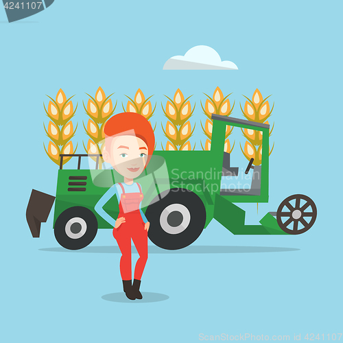 Image of Farmer standing with combine on background.