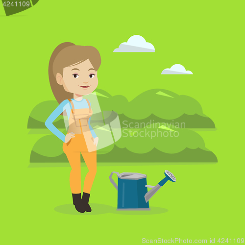 Image of Farmer with watering can at field.