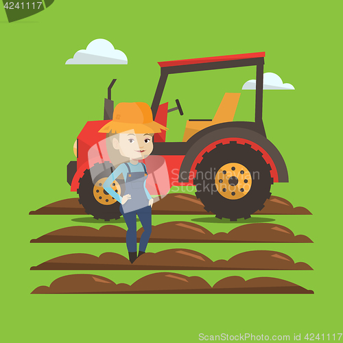 Image of Farmer standing with tractor on background.