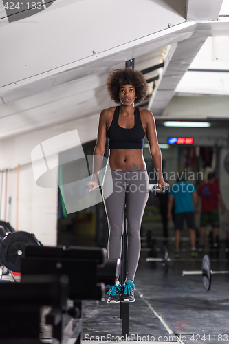 Image of black woman doing parallel bars Exercise