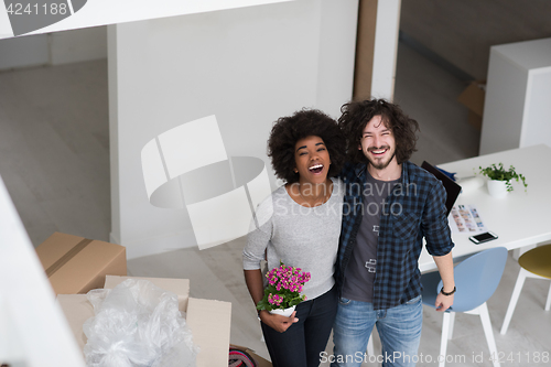 Image of multiethnic couple moving into a new home