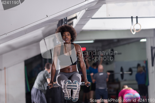 Image of black woman doing parallel bars Exercise