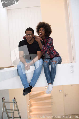 Image of couple having break during moving to new house